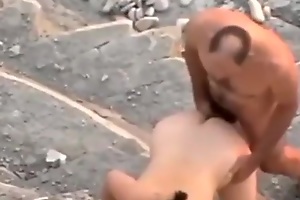 Voyeur tapes a nudist couple shafting in public near the rocks