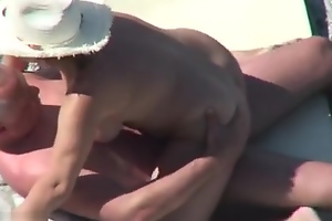 Mature nudist clasp caught fucking readily obtainable the beach